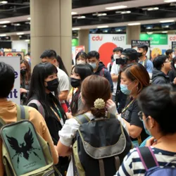 A diverse group of Otaku Gaikokujin Community members at an anime convention