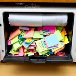 A printer paper tray filled with colorful sticky notes