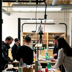 A group of individuals working on biohacking projects in a shared laboratory space