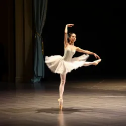 A ballet dancer performing an arabesque on stage